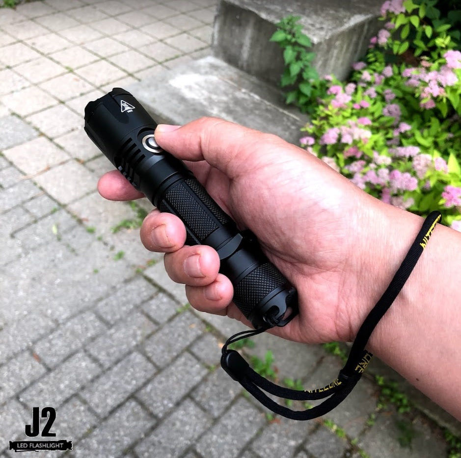 Holding a Nitecore MH25GTS Multitask Hybrid led flashlight